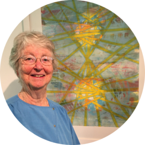 Photo of Anne Johnson in front of her painting